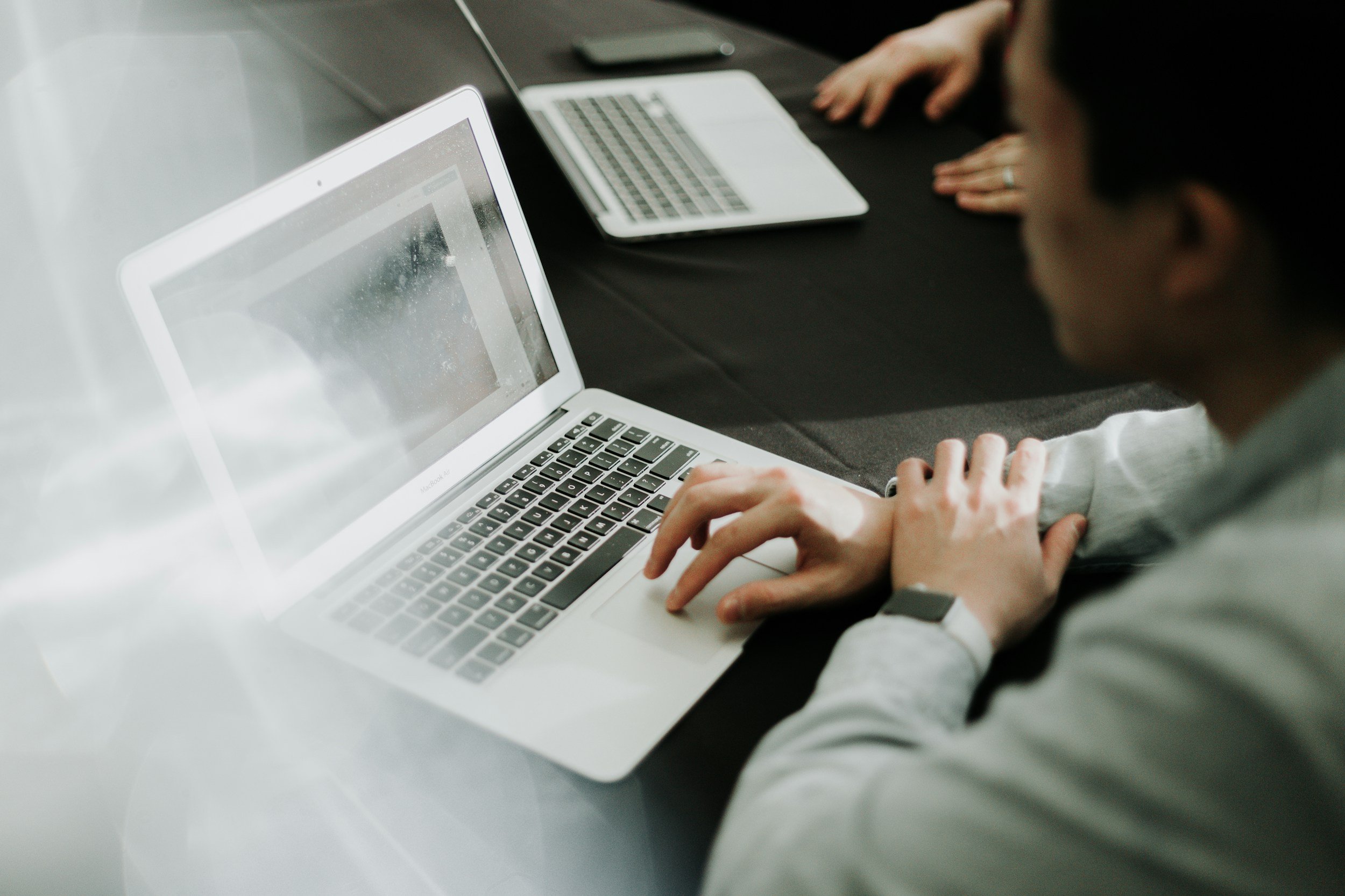 Person on laptop in meeting room